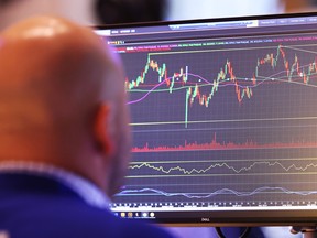 Traders work on the floor of the New York Stock Exchange during morning trading on August 23, 2024 in New York City.