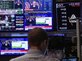 The news conference of Federal Reserve Chair Jerome Powell appears on television screens on the floor of the New York Stock Exchange on Sept. 18, 2024.