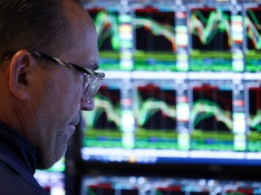 A trader works on the floor of the New York Stock Exchange (NYSE) at the opening bell in New York City on March 10, 2025.