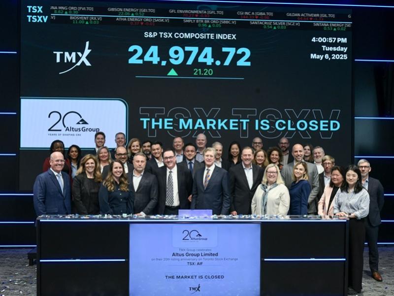 Altus Group employees ring the bell to open the Toronto Stock Exchange in celebration of the firm's 20th year as a publicly traded company. (Courtesy Altus Group)